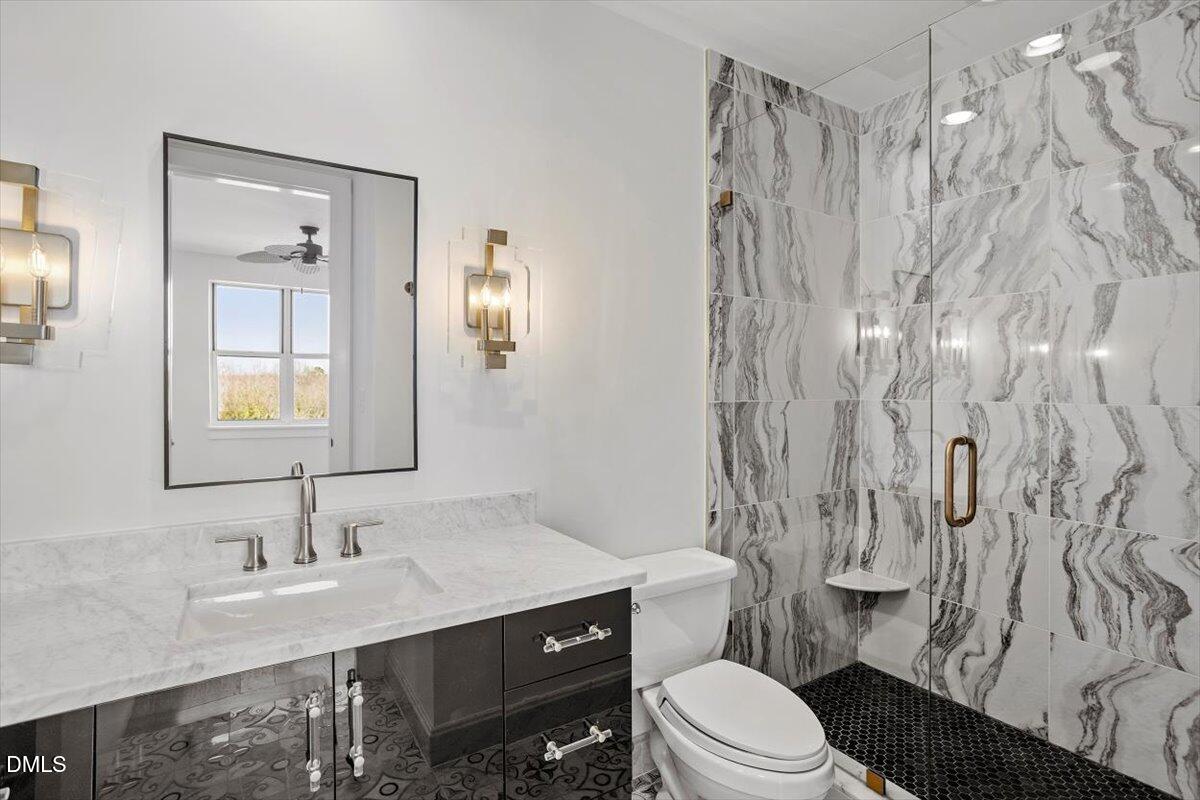 618 North Boylan Avenue, Unit 924 Raleigh, NC 27603 - Photo 16 of 33 a bathroom with a sink a toilet and shower