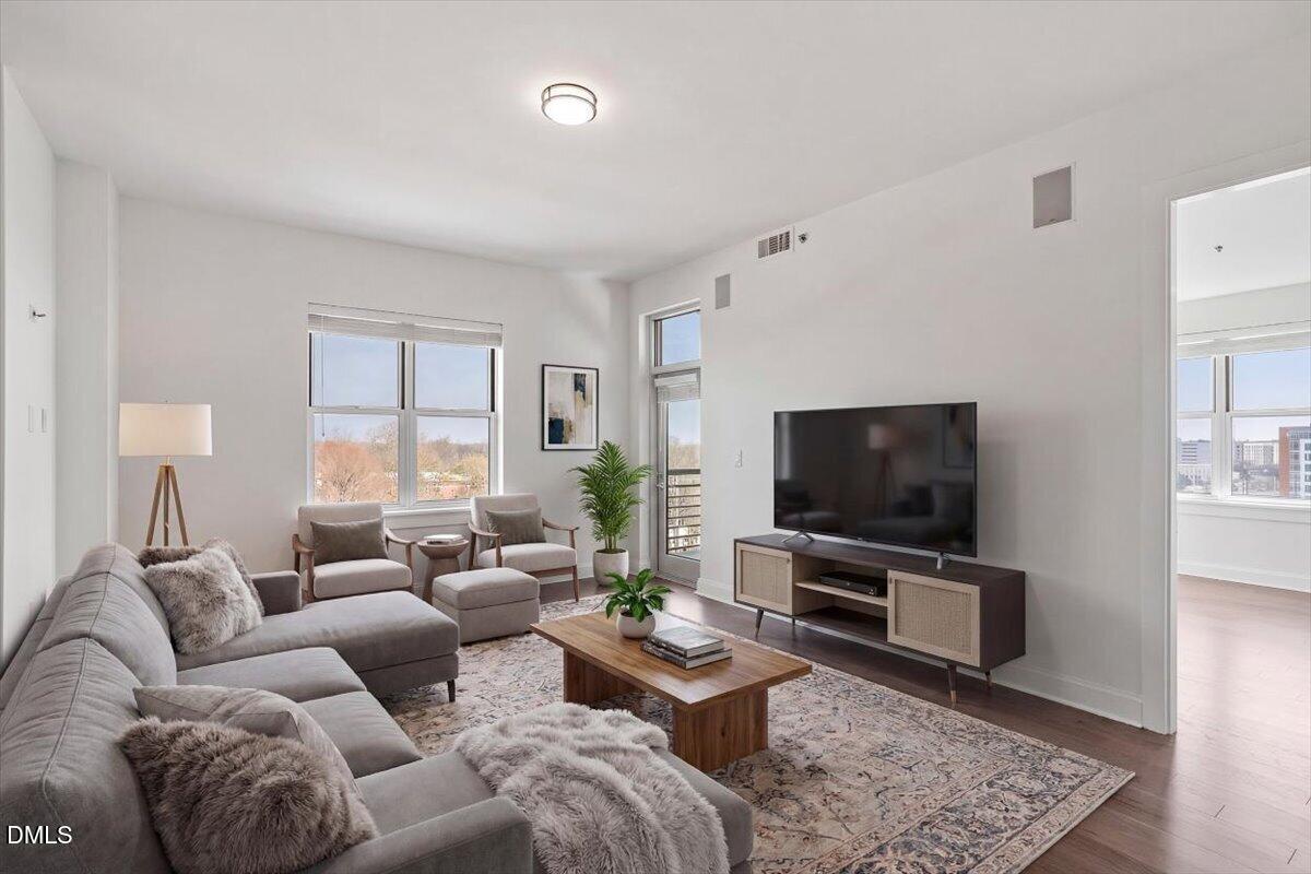 618 North Boylan Avenue, Unit 924 Raleigh, NC 27603 - Photo 2 of 33 a living room with furniture and a flat screen tv