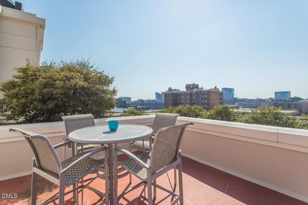 618 North Boylan Avenue, Unit 924 Raleigh, NC 27603 - Photo 24 of 33 a balcony with a table and chairs