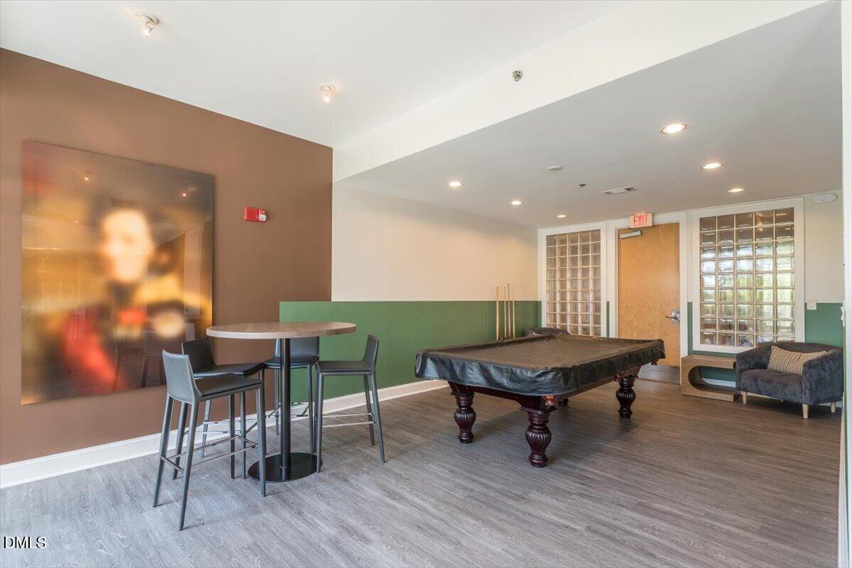 618 North Boylan Avenue, Unit 924 Raleigh, NC 27603 - Photo 30 of 33 a living room with furniture and wooden floor