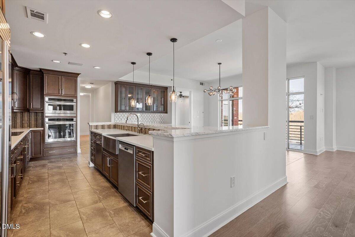 618 North Boylan Avenue, Unit 924 Raleigh, NC 27603 - Photo 5 of 33 a kitchen with stainless steel appliances granite countertop a refrigerator and a stove top oven