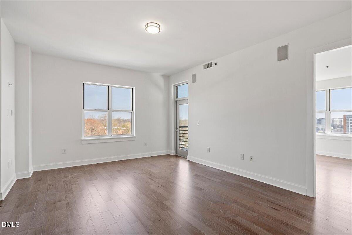 618 North Boylan Avenue, Unit 924 Raleigh, NC 27603 - Photo 8 of 33 an empty room with wooden floor and windows