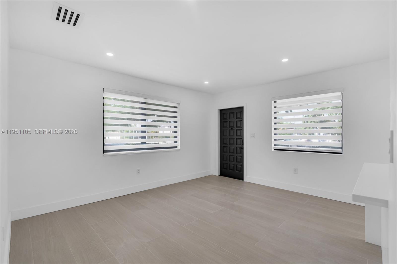 1293 Southwest 22nd Avenue Miami, FL 33135 - Photo 15 of 56 an empty room with windows