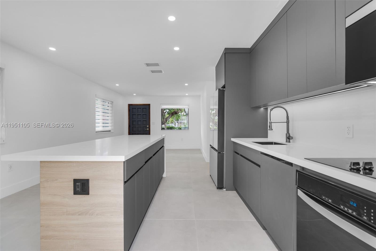 1293 Southwest 22nd Avenue Miami, FL 33135 - Photo 31 of 56 a large kitchen with stainless steel appliances a sink and a stove top oven