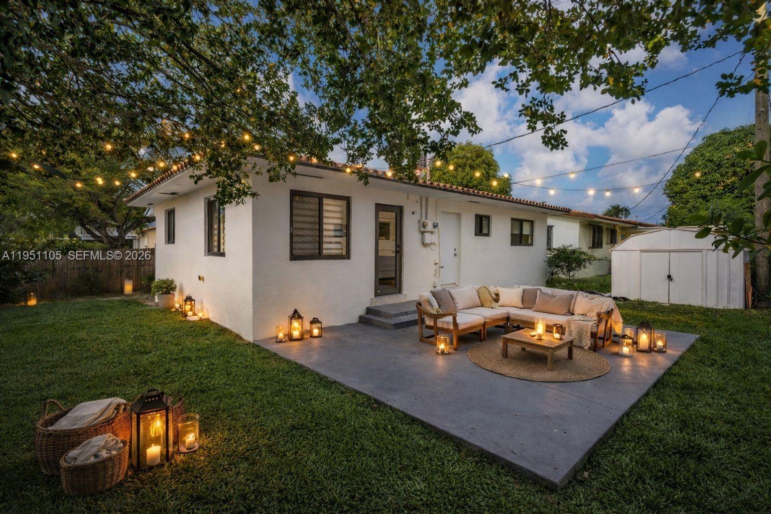 1293 Southwest 22nd Avenue Miami, FL 33135 - Photo 46 of 56 a view of a backyard with table and chairs and a large tree