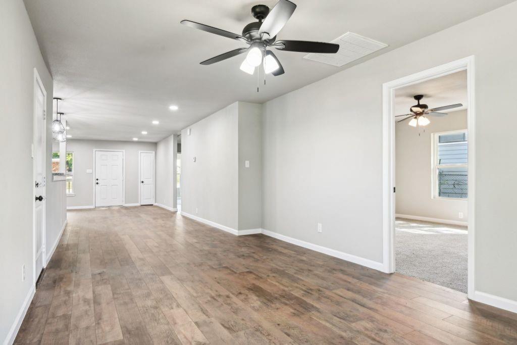 1804 Ransom Terrace Fort Worth, TX 76112 - Photo 2 of 9 wooden floor in an empty room with a window