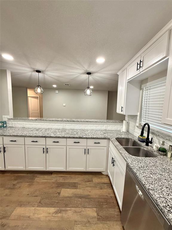 1804 Ransom Terrace Fort Worth, TX 76112 - Photo 4 of 9 a bathroom with a granite countertop sink and white cabinets