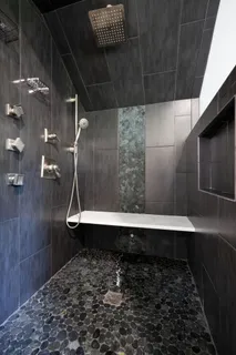 an empty room with windows and chandelier fan