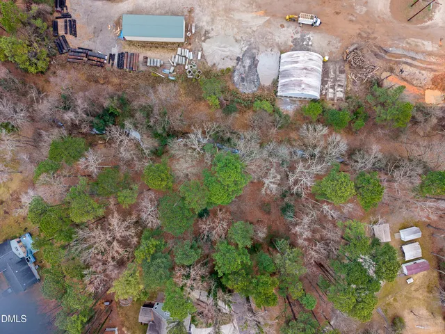 an aerial view of a house with a yard and mountain view in back