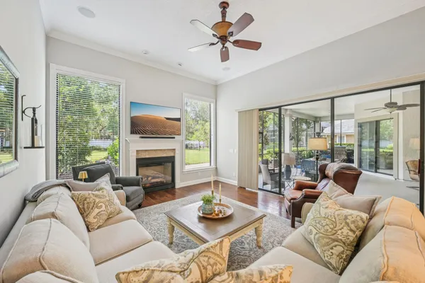 a living room with furniture a fireplace and a large window