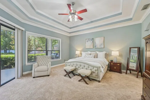 a spacious bedroom with a bed and a large window