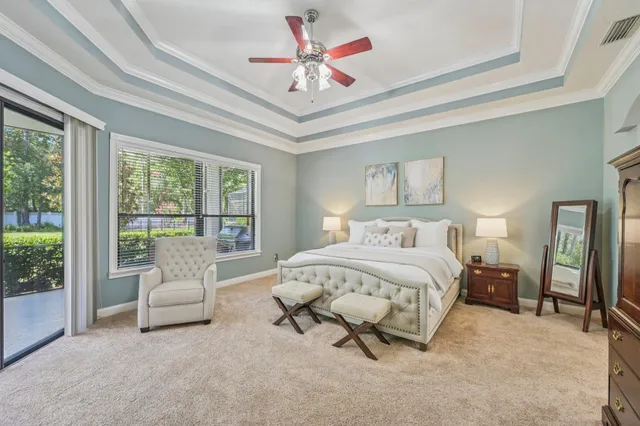 a spacious bedroom with a bed and a large window