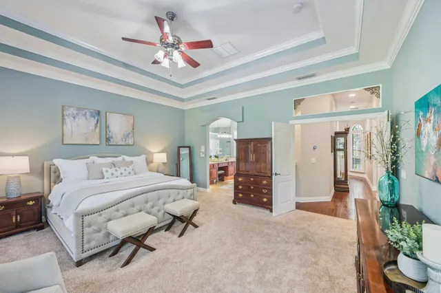a bedroom with a bed a chandelier and closet