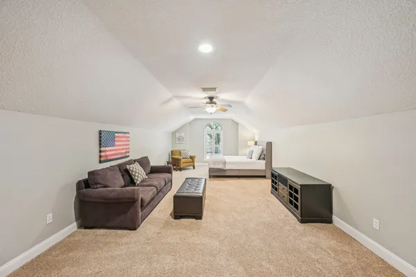 a living room with furniture and a chandelier