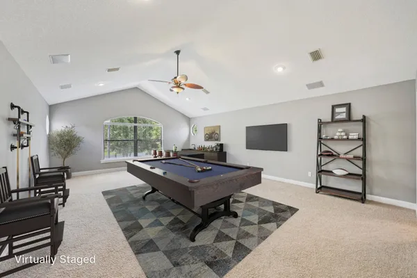 a living room with furniture a flat screen tv and a table