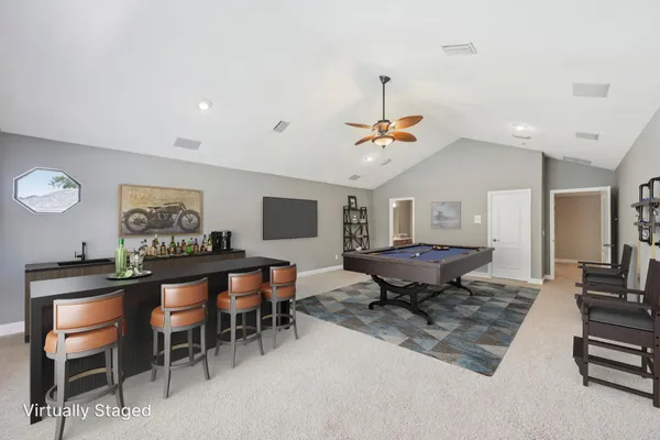 a view of a room with furniture a rug and wooden floor