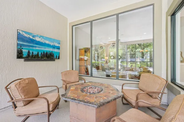 a living room with furniture and a floor to ceiling window