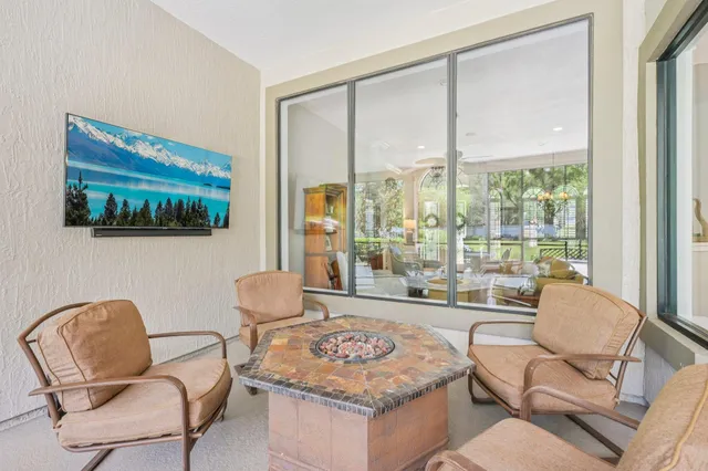 a living room with furniture and a floor to ceiling window