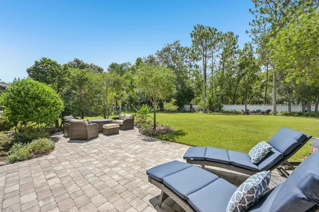 a view of a backyard with sitting area