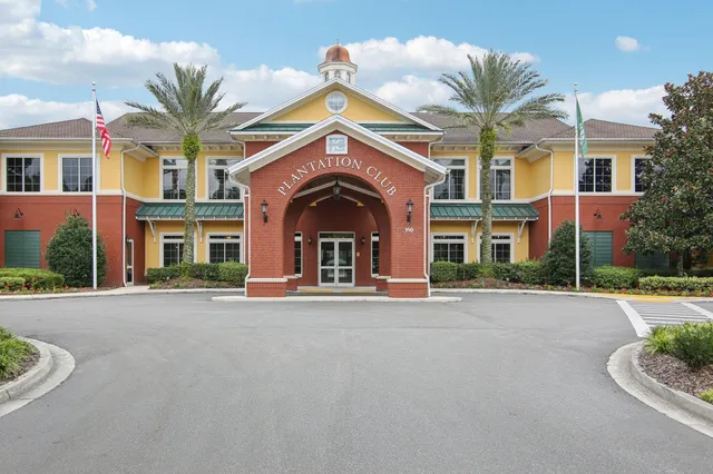front view of a brick house with a yard