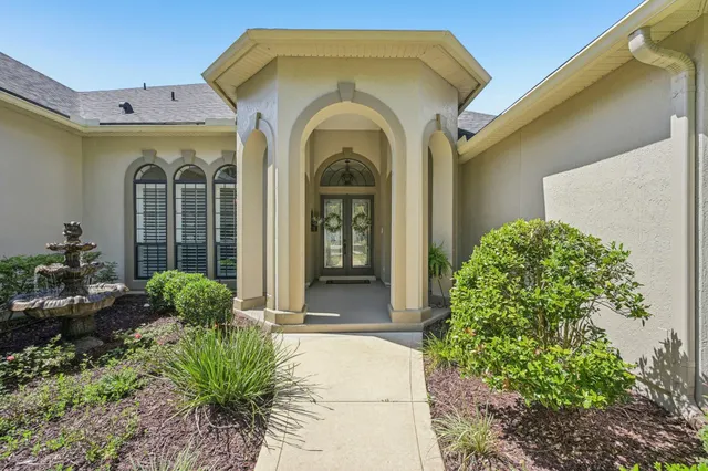 a front view of a house with garden