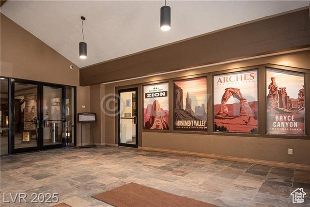 223 Hunter Ridge Drive, Unit E121 Brian Head, UT 84719 - Photo 23 of 35 Cinema featuring stone finish flooring, high vaulted ceiling, and french doors