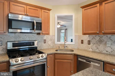 a kitchen with a stove microwave and sink