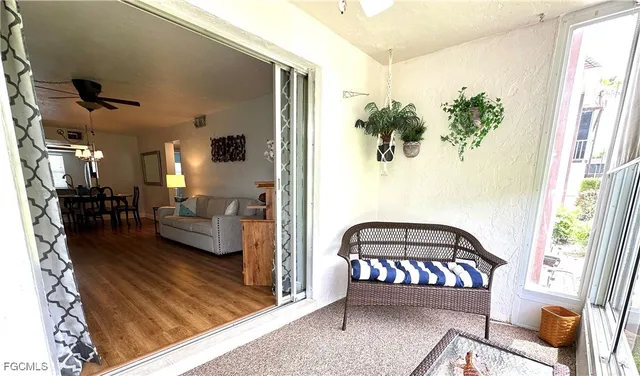 a living room with furniture rug and a window