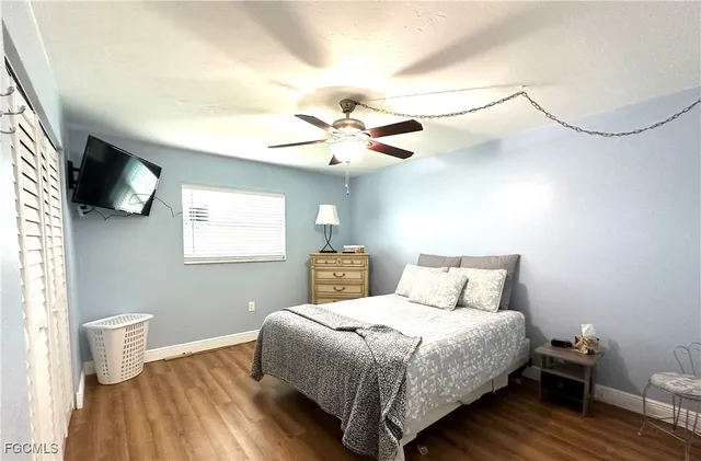 a bedroom with a bed and a ceiling fan