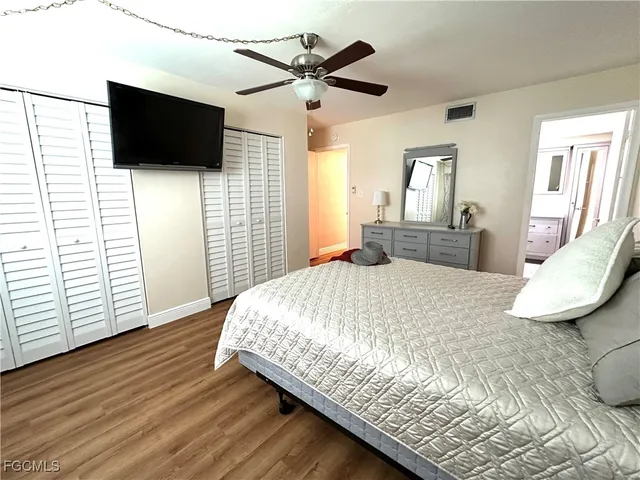 a bedroom with a bed and flat screen tv