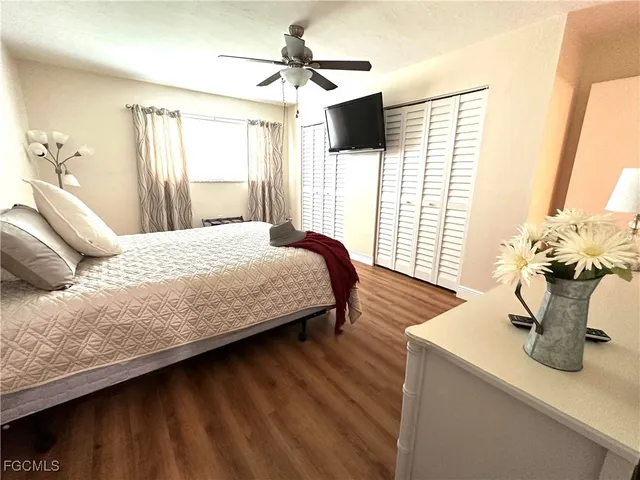 a bedroom with a bed and a flat tv screen