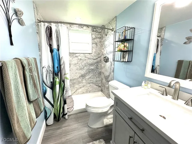 a bathroom with a sink toilet and shower