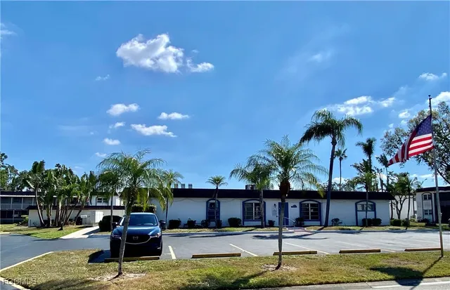a swimming pool view with a seating space