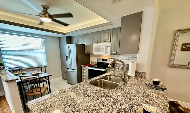 a kitchen with a refrigerator sink and stove