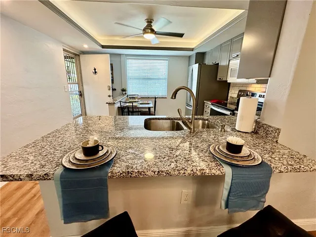 a kitchen with sink and stove