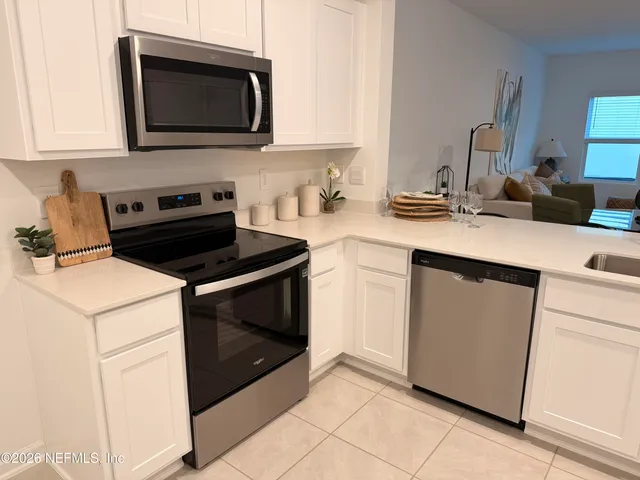 a kitchen with a stove and a microwave