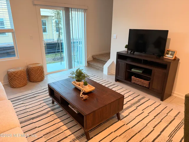 a living room with furniture and a flat screen tv