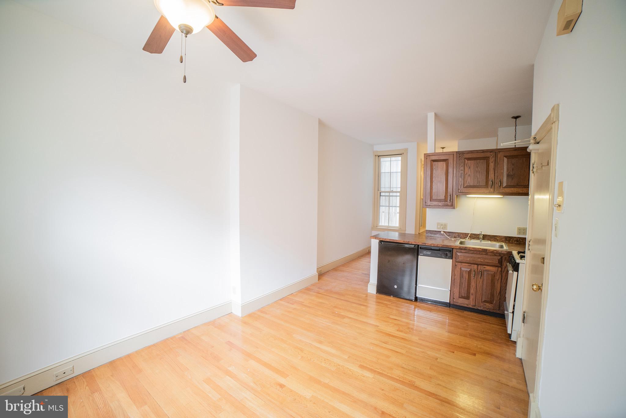 2408 Spruce Street, Unit 1F Philadelphia, PA 19103 - Photo 4 of 11 a kitchen with stainless steel appliances granite countertop a sink and a stove top oven