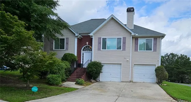 a front view of a house with garden
