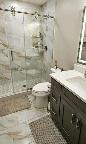 a bathroom with a sink toilet and shower