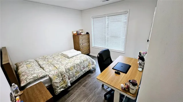 a bedroom with a bed and a table in it