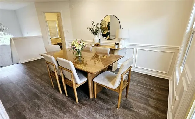 a dining room with furniture and wooden floor
