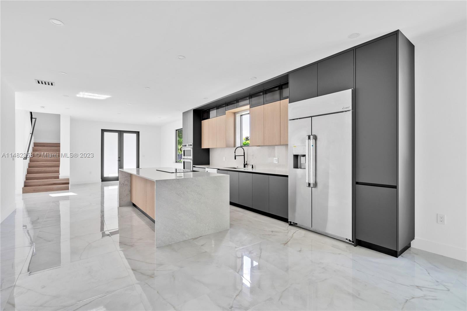 5241 Southwest 6th Street Miami, FL 33134 - Photo 14 of 38 a kitchen with stainless steel appliances a refrigerator sink and cabinets
