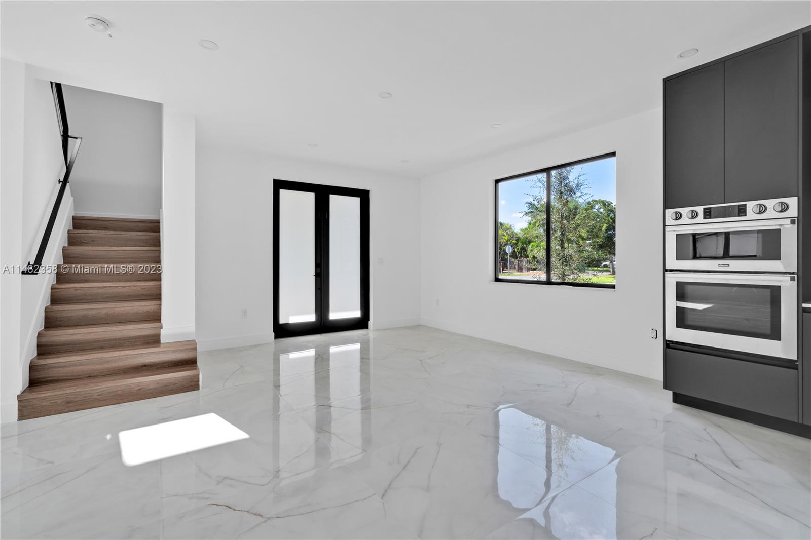 5241 Southwest 6th Street Miami, FL 33134 - Photo 19 of 38 a view of a livingroom with wooden floor and stairs