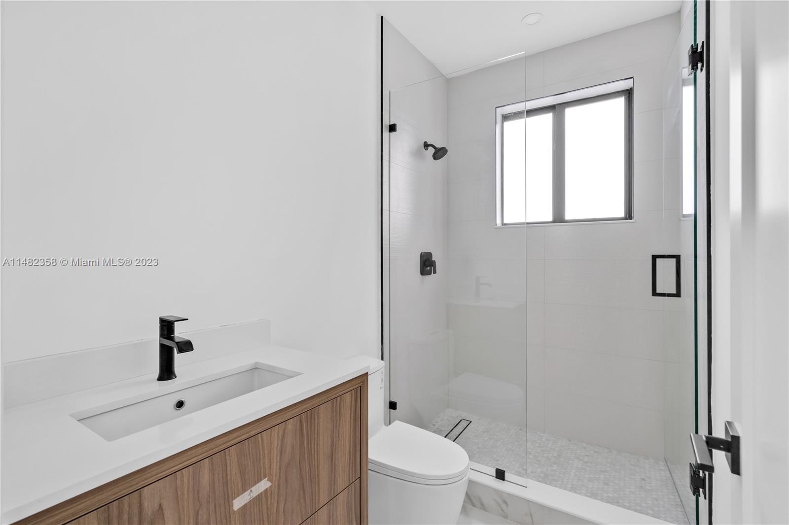 5241 Southwest 6th Street Miami, FL 33134 - Photo 24 of 38 a bathroom with a sink a toilet and shower