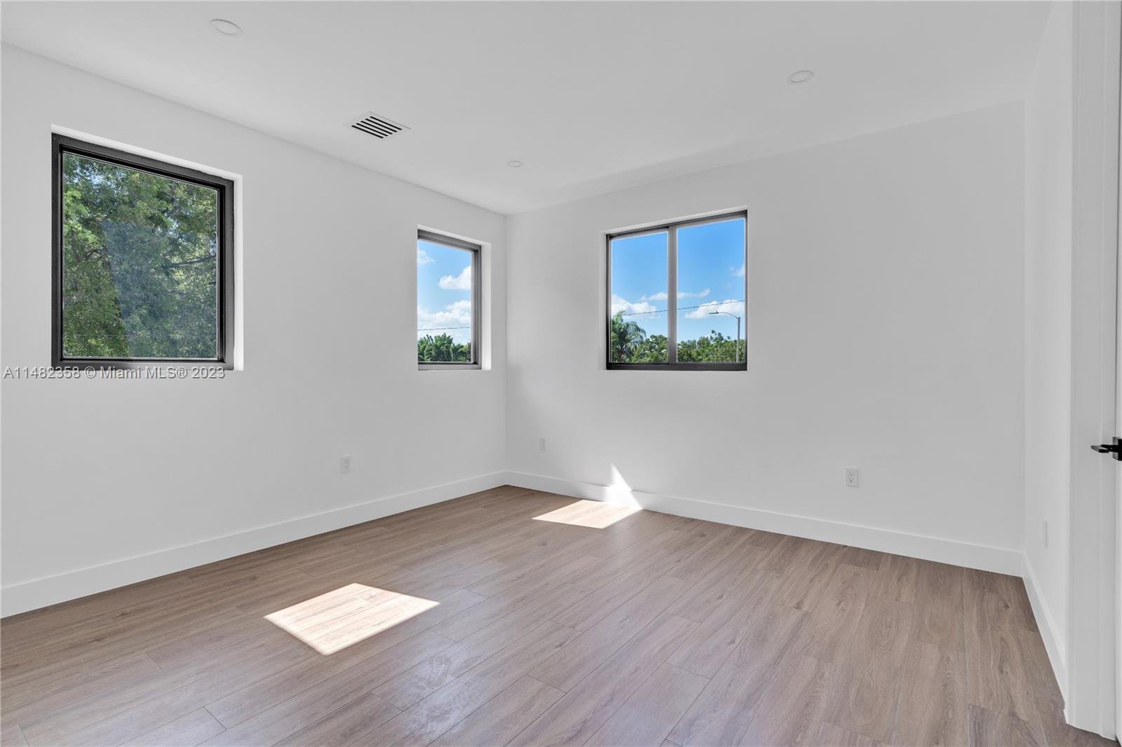 5241 Southwest 6th Street Miami, FL 33134 - Photo 27 of 38 a view of an empty room with wooden floor and a window