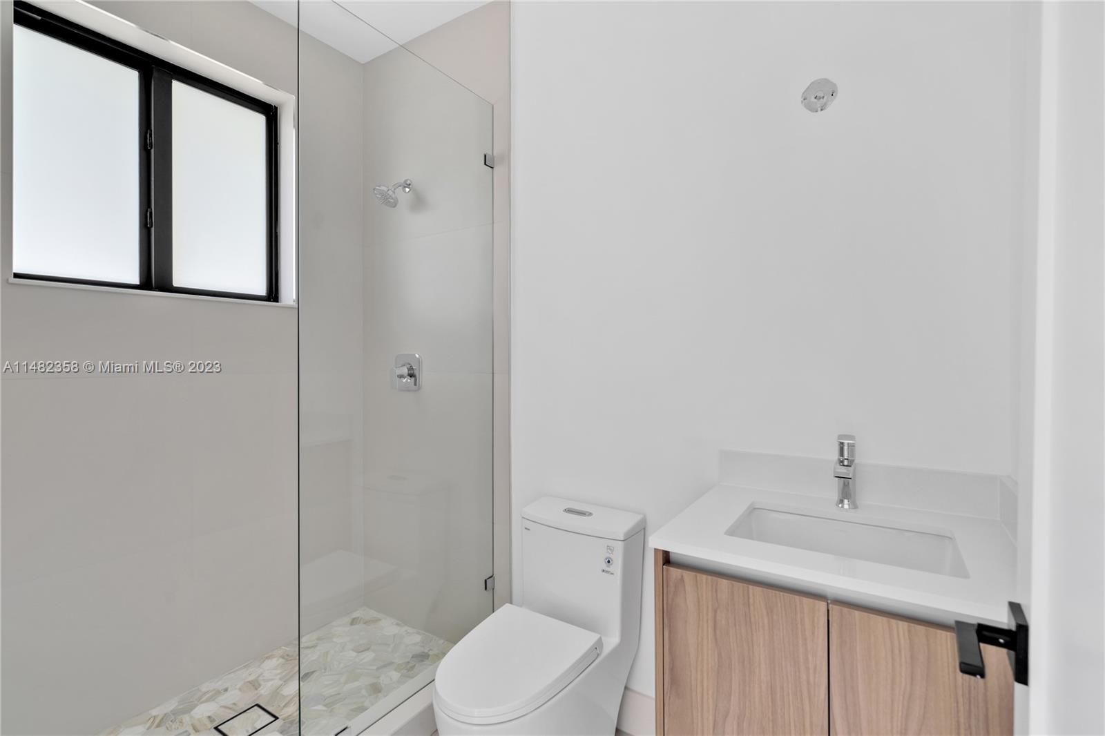 5241 Southwest 6th Street Miami, FL 33134 - Photo 29 of 38 a bathroom with a toilet a sink and shower