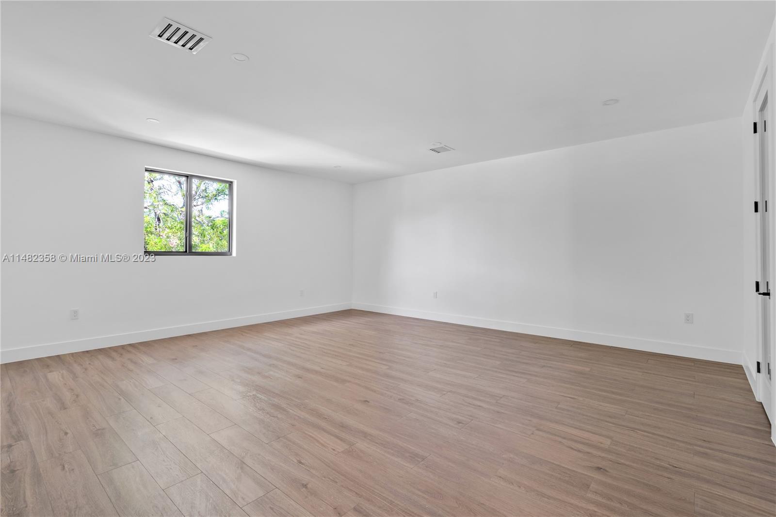 5241 Southwest 6th Street Miami, FL 33134 - Photo 31 of 38 wooden floor in an empty room with a window