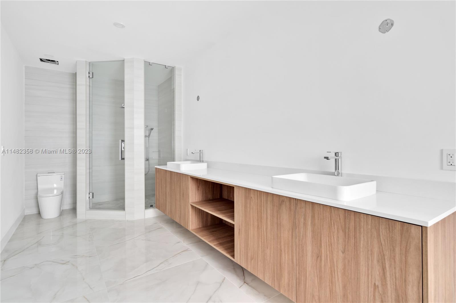 5241 Southwest 6th Street Miami, FL 33134 - Photo 37 of 38 a bathroom with a double vanity sink and a toilet