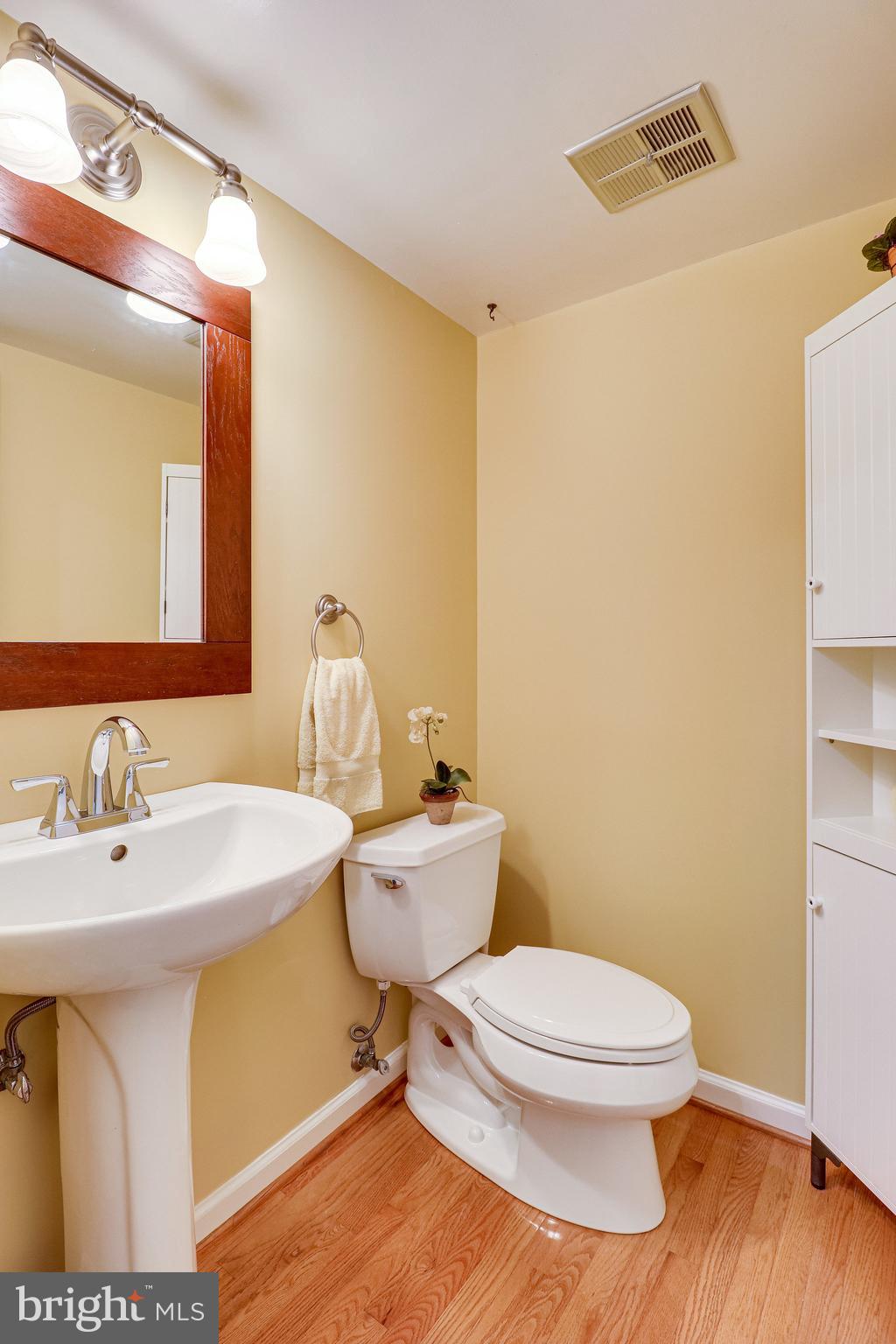 2210 Glencourse Lane Reston, VA 20191 - Photo 31 of 84 Hardwood Flooring Extends into Half Bath